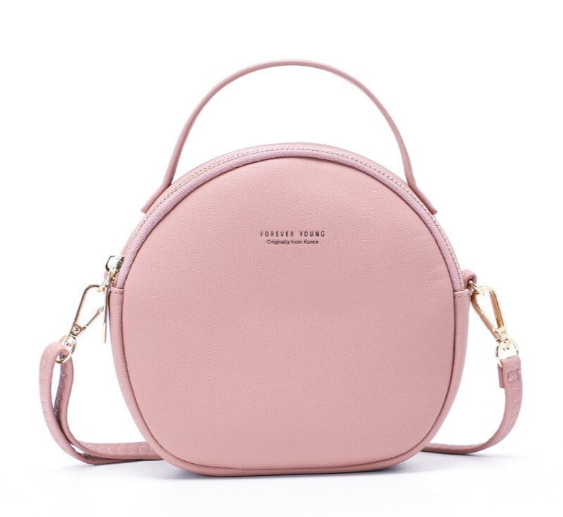 Petit sac à main rond couleur pastel rose